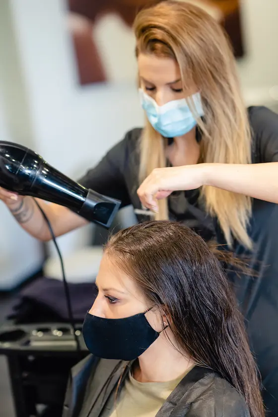 hairdresser-drying-her-client-39-s-hair-with-a-ha-2025-03-25-05-34-08-utc